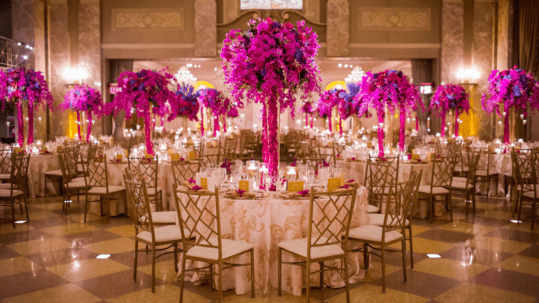 Fuscia Flowers At Tables For Wedding